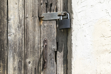 a wooden door with a padlock