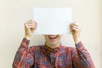 a young man holding poster