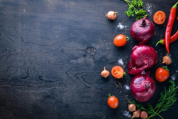Big set organic food. Fresh raw vegetables. On a black chalkboard.