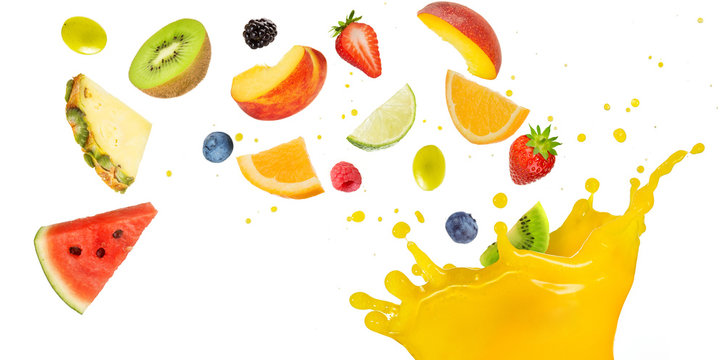 fruit cocktail falling into splashing yellow juice