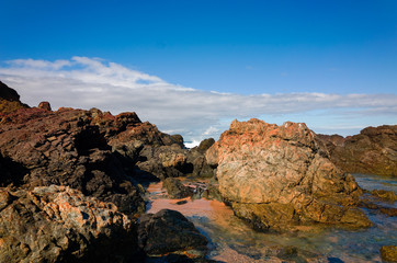Fototapeta na wymiar Large rock formations on sandy beach at Port Macquarie Australia