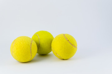 Yellow tennis balls over white with shadow below