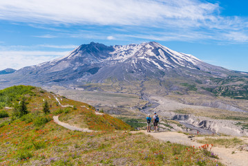 The breathtaking views of the volcano and amazing valley of flowers. Tourists walk along Harry's Ridge Trail. Mount St Helens National Park, South Cascades in Washington State, USA