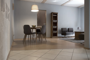 Interior design of a living room with areas for dining and relaxation. Modern, cozy style.