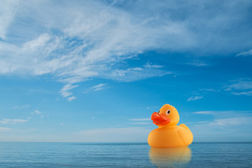 Yellow rubber duck on horizon at sea
