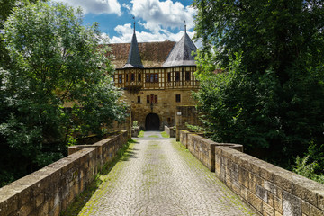 Fototapeta na wymiar Zufahrt zu mittelalterlichem Wasserschloss derer von Bibra (D, Bayern, Unterfranken, Grabfeld, Milzgrund, Irmelshausen)
