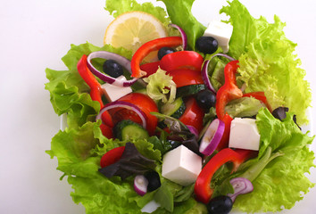 salad from fresh vegetables in a plate on a table, selective focus