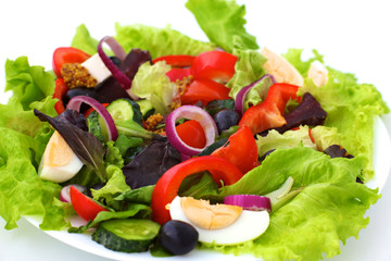 salad from fresh vegetables in a plate on a table, selective focus