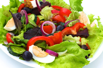 salad from fresh vegetables in a plate on a table, selective focus