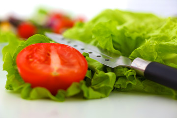 salad from fresh vegetables in a plate on a table, selective focus