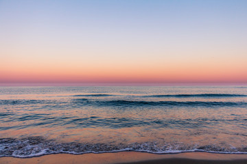 Fototapeta na wymiar Minimalist sunrise with beautiful colours over the sea