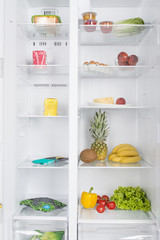 Open fridge full of fresh fruits and vegetables