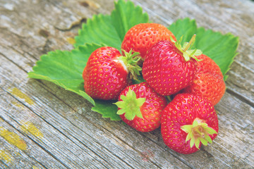  handful of strawberries on wooden background