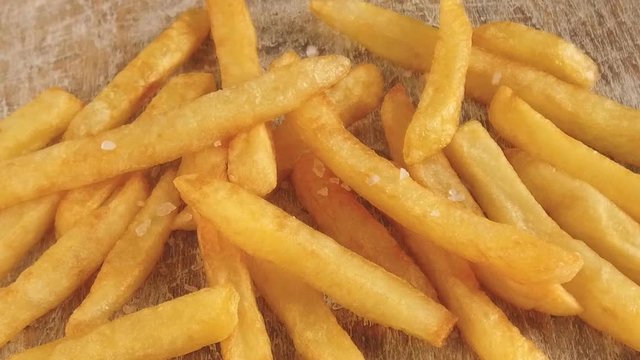 French fries fried potatoes sprinkled with salt slow motion footage video