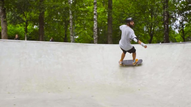 Young man skateboarding at outdoor skate park