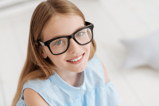 Portrait of adorable girl wearing glasses smiling