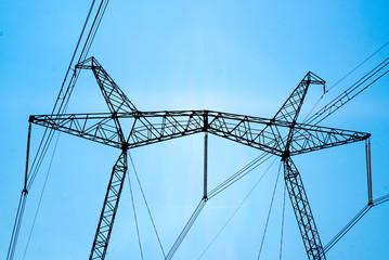 Fototapeta premium Power Lines / Transmission line on background of blue sky