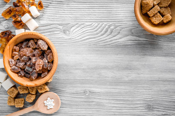 lumps of sugar with bowls sweet set on light table background top view mockup