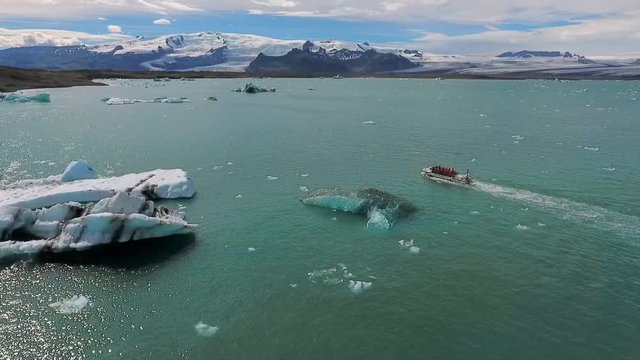 A boat with a group of tourists is floating along the bay in Iceland. Andreev.