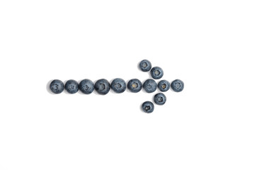 Ripe blueberry arrow isolated on white background. The arrow pointer of purple bilberry
