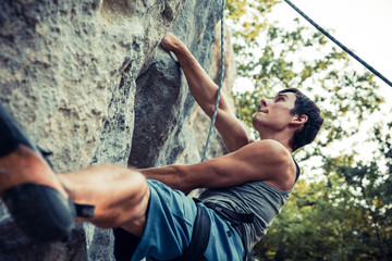 Portrait of a Men climbs a rock