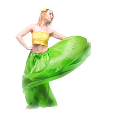 Beautiful young blonde girl in a yellow top, a long green skirt and a hairpin with a flower on her...
