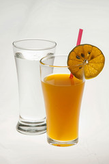 Orange juice in glass with bark on white background