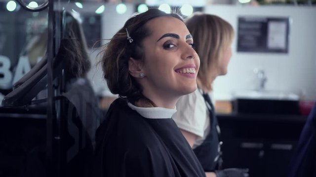 A young girl with painted eyebrows flirts makeup