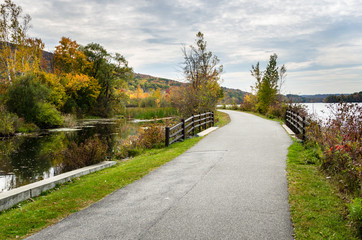 Fototapeta na wymiar Winding Lakeside Path for Pedestrians and Cyclists in Autumn. The Berkshires, MA