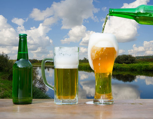Pouring glass of beer from bottle