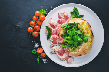 Salad with meat and vegetables. Italian cuisine. On a wooden background. Top view. Free space for your text.