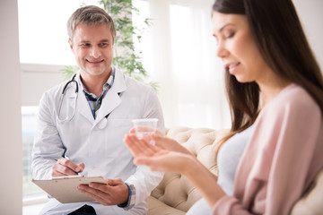 Attractive medical worker making notes