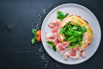 Salad with meat and vegetables. Italian cuisine. On a wooden background. Top view. Free space for your text.