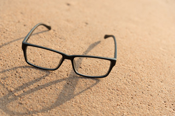 Fototapeta na wymiar black glasses on the beach