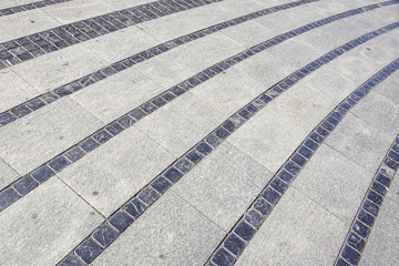 Fototapeta premium Stone pavement texture. Granite cobble stoned pavement background. Abstract background of old cobblestone pavement