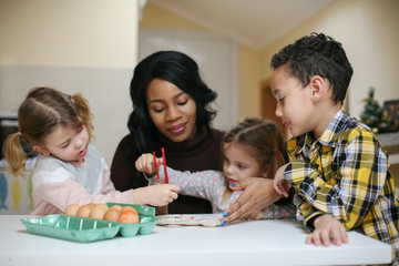 Woman with three child. African American woman with three child prepare for Easter.