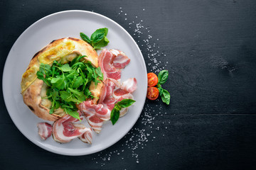 Salad with meat and vegetables. Italian cuisine. On a wooden background. Top view. Free space for your text.