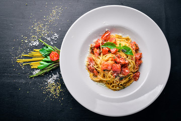 Pasta tomatoes. Italian traditional food. On a wooden background. Top view. Free space for your...