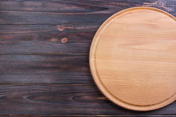 Round cutting board on Old wooden texture background