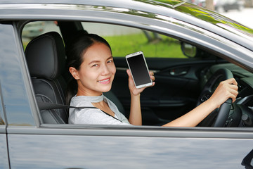 Woman driver using smart phone in car.