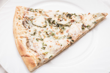 Piece of pizza on a white plate