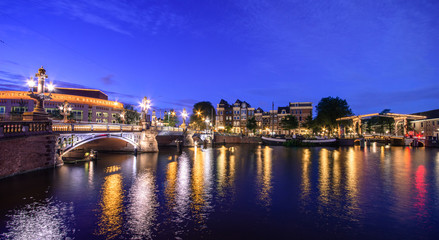 Amsterdam at night, with flowers and bicycles on the bridge, Holland, Netherlands.