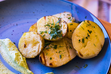 Baked potatoes with herbs on a beautiful plate