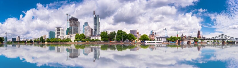 Summer panorama of the financial district with sky towers reflected on the river surface in...