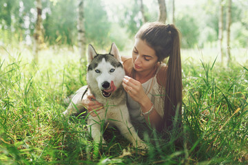 Beauty woman with her dog playing outdoors © Yuliya