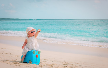 cute little girl travel on summer beach