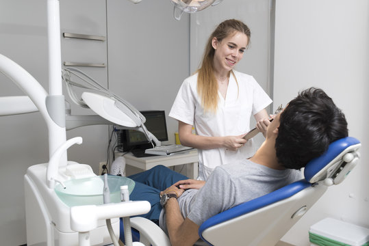 Dentist talking with patient