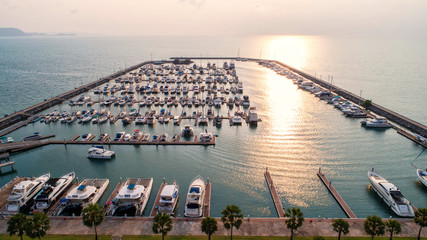 Fototapeta premium Pier speedboat. A marina lot. This is usually the most popular tourist attractions on the beach.Yacht and sailboat is moored at the quay.Aerial view by drone.Top view.