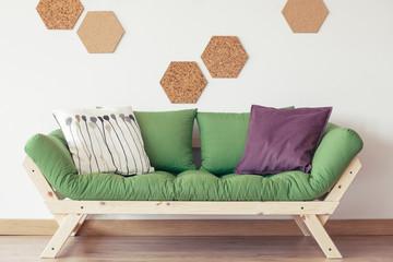 Green sofa in nature-inspired interior