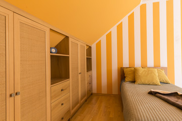 White and orange bedroom with small bed
